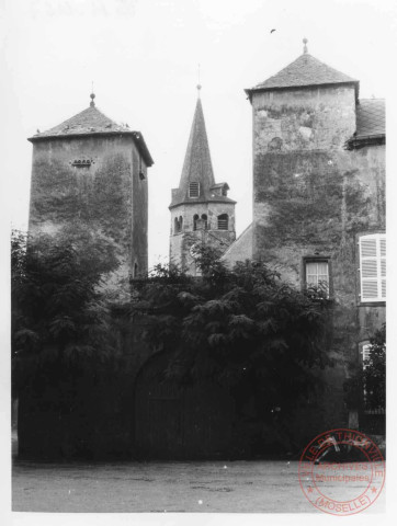 Maison située 2 place Saint-Vincent de Paul à Cattenom. Les 2 tours sont sans doute du XVIIe. Au fond l'église Saint-Martin