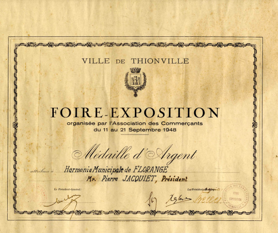 Foire-Exposition organisée par l'Association des commerçants du 11 au 21 septembre 1948. Médaille d'argent attribuée à l'Harmonie de Florange - Mr Pierre JACQUIET, Président.